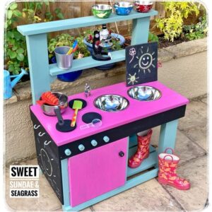 Mud Kitchen with an Oven painted in a combination of Seagrass and Sweet Sundae outside in a garden